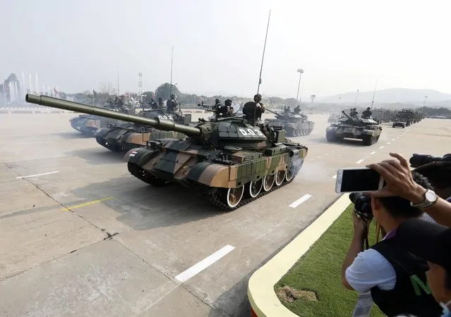 Myanmar soldiers stand on the armor tanks during a parade commemorating the 77th Armed Forces Day in Naypyidaw Myanmar, 27 March 2022. (Photo by Nyein Chan Naing/EPA/EFE)
