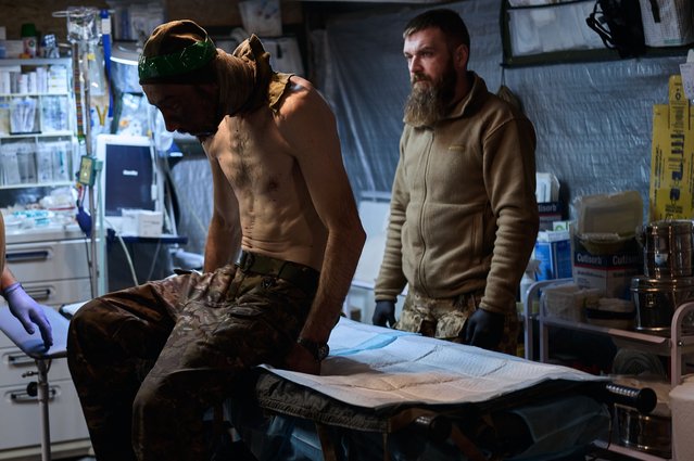 A soldier with a jaw wound who administered first aid to himself and was unable to leave his position for two days with this wound. Medics provide first aid at a stabilisation point near the frontline on November 17, 2024 near the Kurakhove frontline, Donetsk Oblast, in eastern Ukraine. (Photo by Vlada Liberova/Libkos/Getty Images)