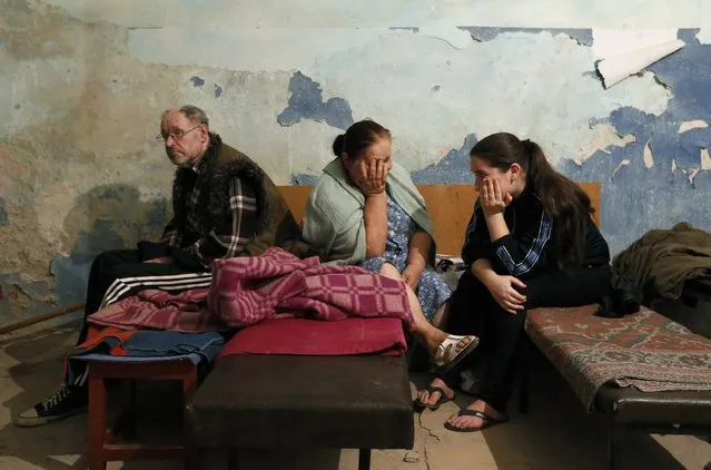 Local residents sit inside a bomb shelter where they are seeking refuge during what they say is shelling in Donetsk August 9, 2014. More than 1,100 people have been killed in the fighting in Ukraine since mid-April, according to the United Nations, in a civil conflict that has dragged ties between Russia and the West to their lowest since the Cold War. (Photo by Sergei Karpukhin/Reuters)