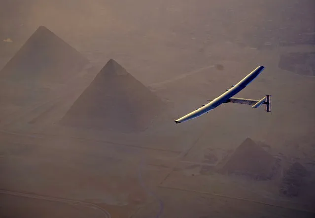 In this Wednesday, July 13, 2016, handout image provided by Solar Impulse, the Solar Impulse 2 flying over the pyramids, Egypt Cairo. The experimental solar-powered airplane has arrived in Egypt as part of its global voyage. (Photo by Jean Revillard, Rezo via the AP Photo)