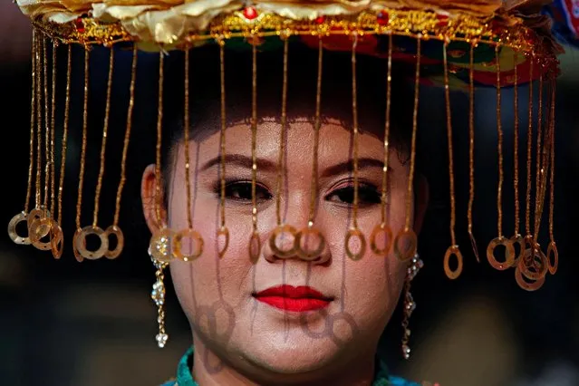 A traditional dancer looks on during her performance in Jakarta, Indonesia on July 26, 2022. (Photo by Ajeng Dinar Ulfiana/Reuters)
