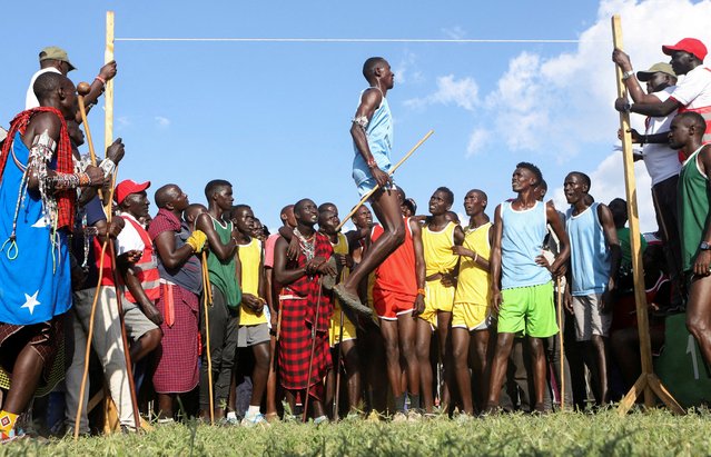 A Maasai moran competes in a traditional high-jump event during the social sporting event dubbed the Maasai Olympics to offer the warriors an alternative to killing lions as part of their traditional rite of passage, in the Kimana sanctuary, at the base of Mt. Kilimanjaro, near the Kenya-Tanzania border in Kimana, Kajiado, Kenya on December 14, 2024. (Photo by Onsase Juma/Reuters)