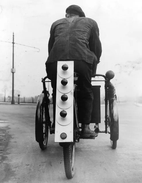 A tricycle fitted with fog lights and special red lamps, designed to act as pilots for buses during foggy weather. 25th February 1935. (Photo by William Vanderson/Fox Photos)