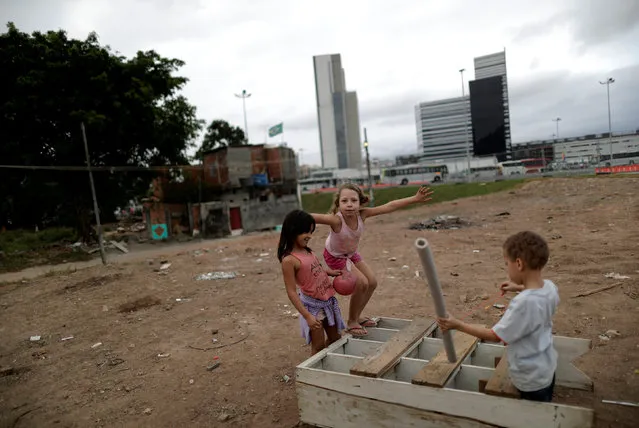 Children play in the Vila Autodromo slum, next to the 2016 Rio Olympic Park, in Rio de Janeiro, Brazil, July 29, 2016. (Photo by Ricardo Moraes/Reuters)