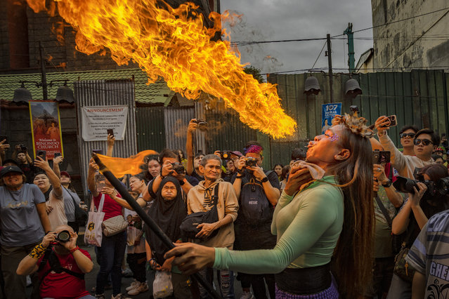 A performer breathes fire during Lunar New Year celebrations at Binondo district, considered the world's oldest Chinatown, on January 29, 2025 in Manila, Philippines. Chinese New Year, also known as Lunar New Year, will begin on January 29, 2025, marking the Year of the Snake. The celebrations, which last for approximately 15 days, are filled with traditional activities such as family gatherings, lion dances, and the exchange of red envelopes, making it a vibrant cultural event observed by Chinese communities worldwide. (Photo by Ezra Acayan/Getty Images)