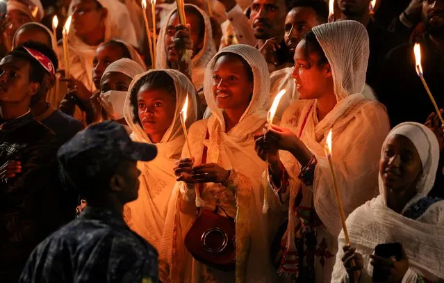 Ethiopian Orthodox faithful hold candles during the Meskel festival celebration to commemorate the discovery of the true cross on which Jesus Christ was crucified on, at Meskel square, in Addis Ababa, Ethiopia on September 26, 2022. (Photo by Tiksa Negeri/Reuters)