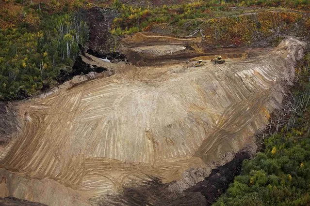 Bulldozers work clearing an area at the new Suncor Fort Hills tar sands mining operations near Fort McMurray, Alberta, September 17, 2014. (Photo by Todd Korol/Reuters)