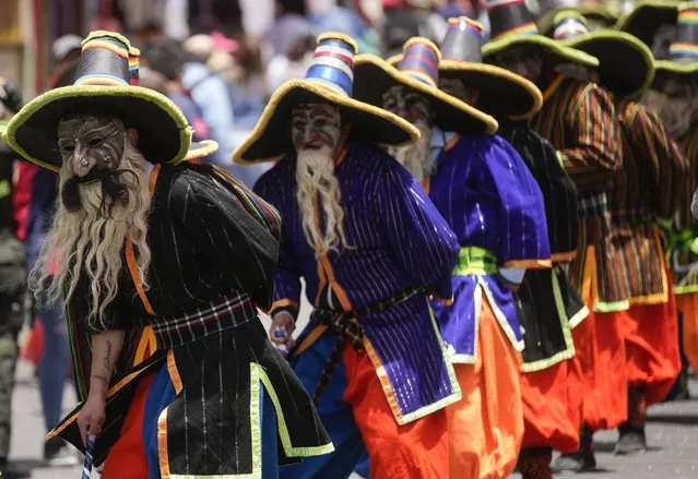 Students perform in the traditional “Auqui Auqui” dance during the University Folk Fair, in La Paz, Bolivia, Saturday, October 22, 2022. Thousands turned out to celebrate Bolivia’s folkloric traditions in the after the event was cancelled for 3 years due to the COVID-19 pandemic restrictions. The participating students are organized in floats and dance groups, dancing mainly autochthonous and folkloric dances, with the objective of defending, revaluing and promoting the cultural heritage of La Paz. (Photo by Juan Karita/AP Photo)