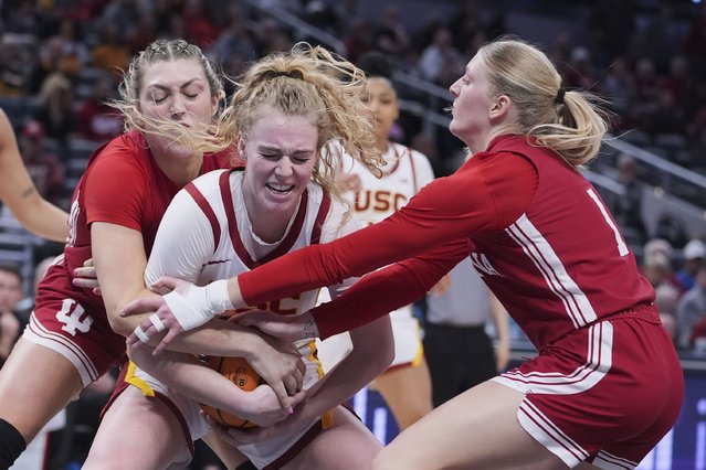 Southern California guard Avery Howell (23) is trapped by Indiana forward Karoline Striplin, left, and guard Lexus Bargesser (1) in the second half of an NCAA college basketball game in the quarterfinals of the Big Ten Conference tournament in Indianapolis, Friday, March 7, 2025. (Photo by Michael Conroy/AP Photo)