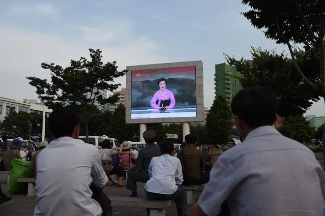 A giant screen broadcasts news coverage of a ballistic missile test conducted by the Hwasong artillery units of the KPA Strategic Force, in a public square in Pyongyang on July 20, 2016. North Korea said on July 20 its latest ballistic missile tests trialled detonation devices for possible nuclear strikes on US targets in South Korea and were personally monitored by leader Kim Jong-Un. (Photo by Kim Won-Jin/AFP Photo)