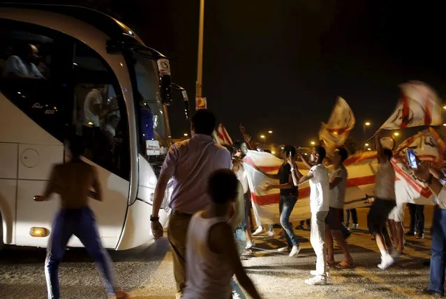 The bus carrying El Zamalek players is stopped by cheering fans in a street outside Petro Sport stadium after they won their Egyptian Cup finals derby soccer match against Al Ahly in Cairo, Egypt, September 21, 2015. (Photo by Amr Abdallah Dalsh/Reuters)
