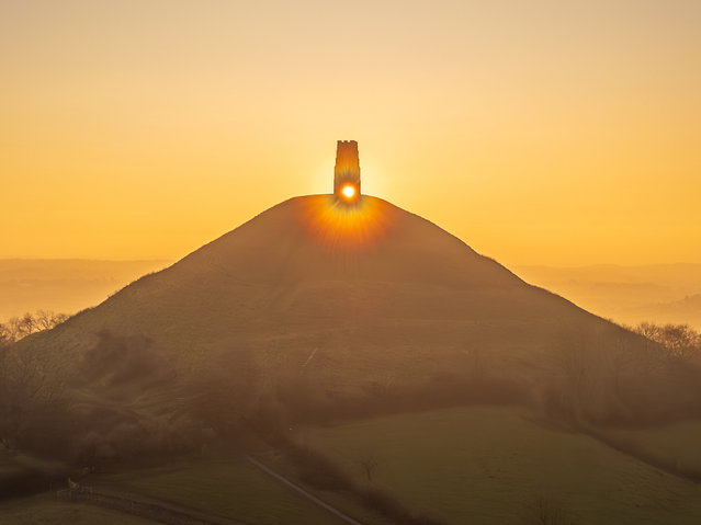 Glastonbury Tor in UK, topped by a 15th-century tower, at sunset on Wednesday, January 22, 2025. (Photo by Michelle Cowbourne/South West News Service)