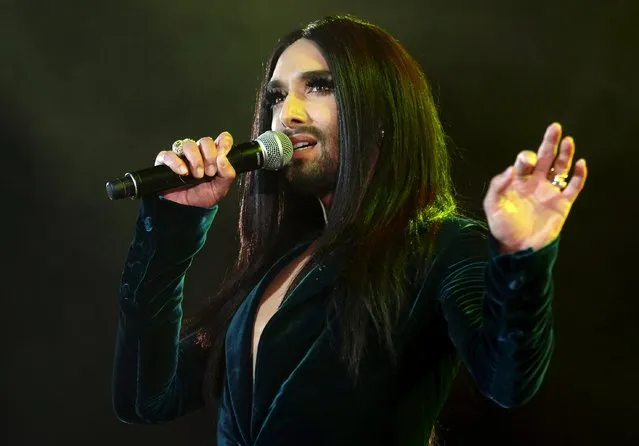 Eurovision Song Contest winner Conchita Wurst of Austria performs in front of some 100,000 visitors, according to organizers, during a "Voices for Refugees" solidarity concert at Heldenplatz square in Vienna, Austria, October 3, 2015. (Photo by Heinz-Peter Bader/Reuters)