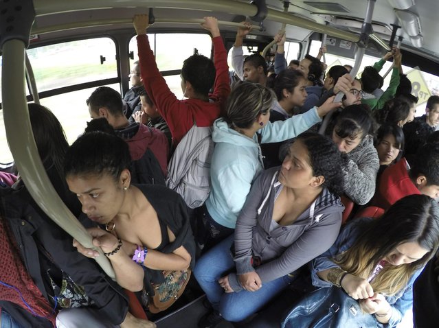 Passengers ride a Transmilenio system bus during rush hour in Bogota, October 27, 2014. A Thomson Reuters Foundation survey of 15 of the world's largest capitals and New York found Bogota in Colombia ranked as having the most unsafe public transport, with women scared to travel after dark, followed by Mexico City, Lima, then Delhi. (Photo by John Vizcaino/Reuters)