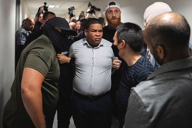 A migrant is detained by federal immigration officers at U.S. immigration court in Manhattan, in New York City, U.S., June 6, 2025. (Photo by David 'Dee' Delgado/Reuters)