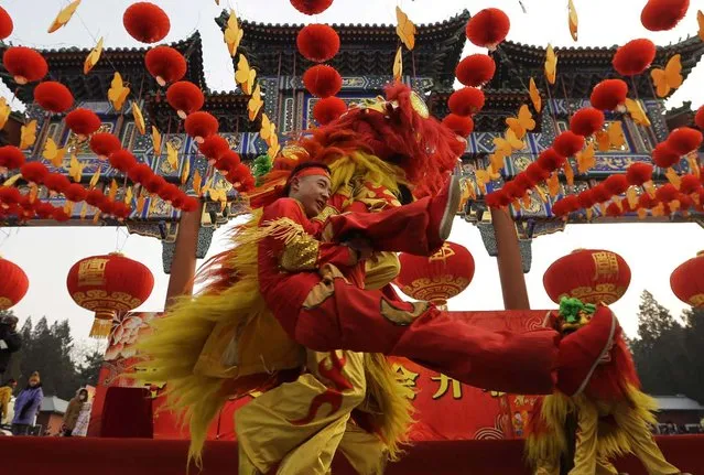 Chinese artists perform the lion dance during the opening ceremony of the Spring Festival Temple Fair at Ditan Park (the Temple of Earth), in Beijing, February 9, 2013. The Lunar New Year, or Spring Festival, begins on February 10 and marks the start of the Year of the Snake, according to the Chinese zodiac. (Photo by Jason Lee/Reuters)