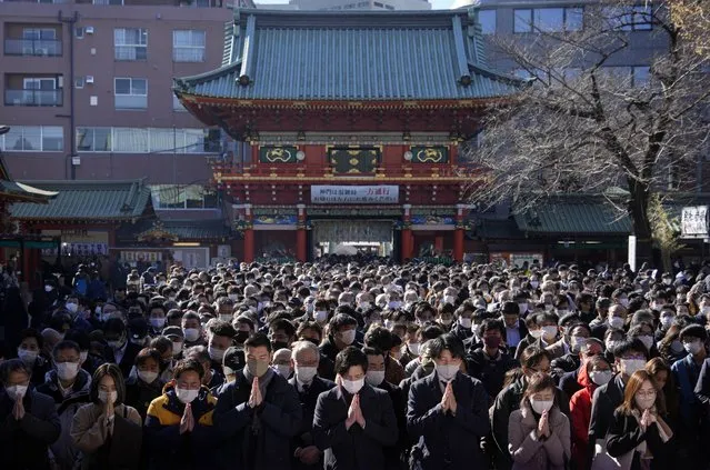 Business people offer prayers for prosperity for their companies and the economy on the first business day of the year at the Kanda Myojin Shrine in Tokyo, Japan, 04 January 2023. Thousands of people visited the shrine on the first business days of the New Year to pray for prosperity in their business endeavors. (Photo by Franck Robichon/EPA/EFE)