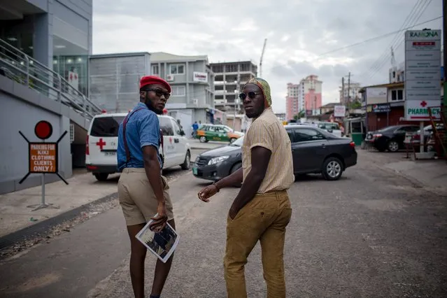 Fashion stylist Daniel Quist (L) and DJ Evans Kissi look back at the photographer as they walk down a street in Accra, Ghana, June 10, 2015. (Photo by Francis Kokoroko/Reuters)