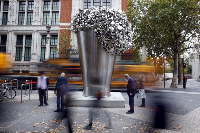 Commuters walk past an installation by artist Subodh Gupta outside the V&A in London, Britain October 23, 2015. (Photo by Stefan Wermuth/Reuters)