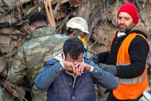 Brother of survivor Gokhan Ugurlu, 35, reacts as rescuers work in the aftermath of a deadly earthquake, in Hatay, Turkey on February 12, 2023. (Photo by Kemal Aslan/Reuters)