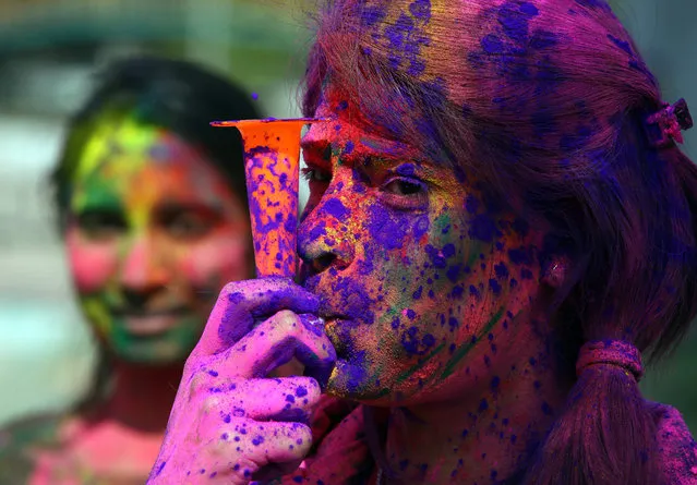 A student daubed in colours plays a bigul toy during Holi celebrations on a university campus in Chandigarh, India March 2, 2018. (Photo by Ajay Verma/Reuters)
