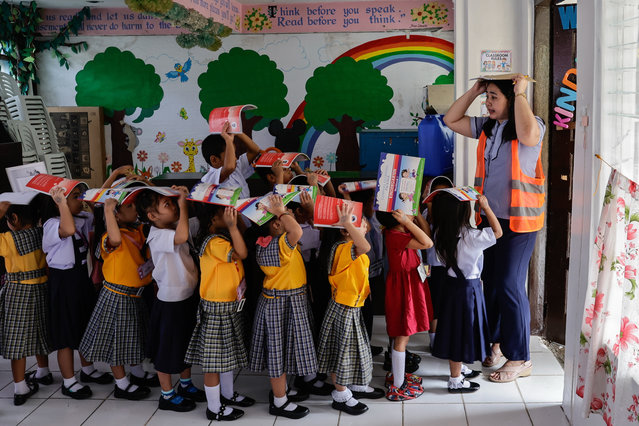 A teacher guides kindergarten students during an earthquake drill at an elementary school in Quezon City, Metro Manila, Philippines, 19 June 2025. The Philippines conducted the second quarterly nationwide earthquake drill on 19 June, as authorities remind the public to actively participate in emergency exercises to improve responses in times of actual disasters. (Photo by Rolex dela Peña/EPA/EFE)