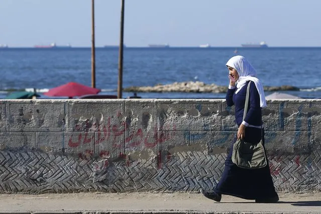 A student walks over a bridge after school near the fishermen's village in El Max in the Mediterranean city of Alexandria October 18, 2014. (Photo by Amr Abdallah Dalsh/Reuters)