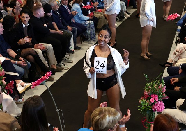 Belgian Shai Zomers, 54, who took part in the 9-month Top Women 2024 coaching, to help women to be “as they are” and “to gain confidence in who they are”, smiles on the catwalk in Mons, Belgium on May 19, 2024. (Photo by Yves Herman/Reuters)