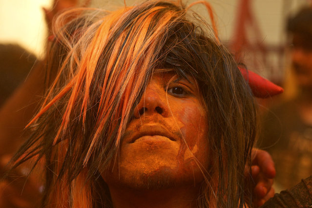 A person smeared with colors celebrate Holi festival in Hyderabad, India, Monday, March 6, 2023. The festival will be observed on March 8, but the festivities starts almost a week in advance. It is celebrated across India to welcome good harvests, warm weather, and the defeat of evil. (Photo by Mahesh Kumar A./AP Photo)