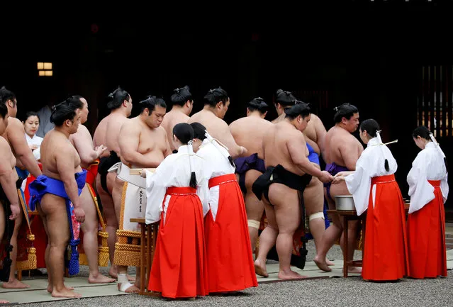 Sumo wrestlers take part in a Shinto ritual before the start of an annual sumo tournament dedicated to the Yasukuni Shrine in Tokyo, Japan on April 16, 2018. (Photo by Toru Hanai/Reuters)