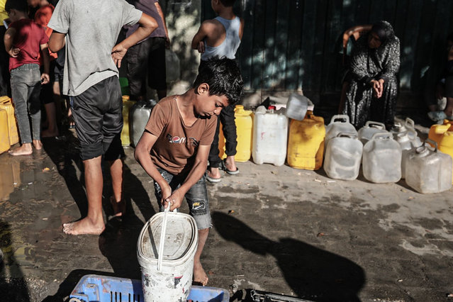 Civilians displaced by the Israeli offensive in the northern part of the Palestinian territory gather water distributed from tankers in Nuseirat refugee camp, Gaza on October 1, 2025. (Photo by Moiz Salhi/APAImages/Rex Features/Shutterstock)