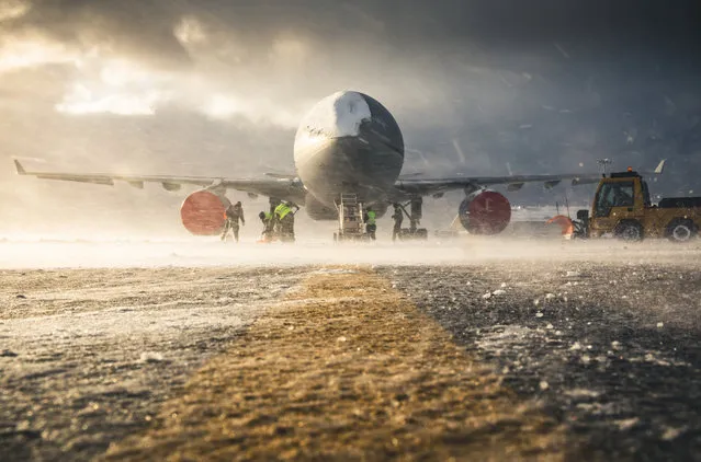Operations & Exercises, 1st place. An RAF Voyager aircraft sits in the harsh winter weather at Mount Pleasant Complex, Falkland Islands, while personnel work to ensure the snow is cleared. (Photo by Sgt Andy Holmes/2020 RAF Photo Competition)