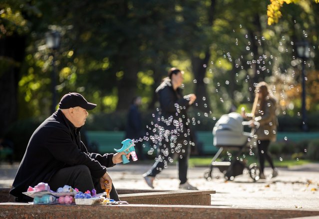 A man sells bubble maker toys in a sunny day in Central Park Chisinau, Moldova, 27 October 2024. Moldova will hold the second round of presidential election, between incumbent Moldovan President Maia Sandu and former prosecutor general Alexandr Stoianoglo, on 03 November 2024. (Photo by Dumitru Doru/EPA/EFE)