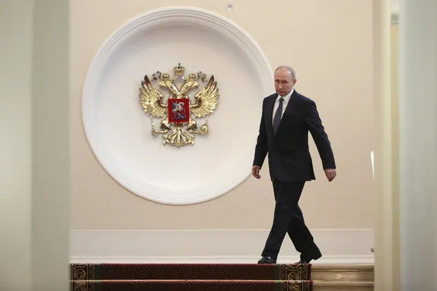Vladimir Putin enters to take the oath during his inauguration ceremony as new Russia's president in the Grand Kremlin Palace in Moscow, Russia, Monday, May 7, 2018. Putin won the six-year term in March elections where he tallied 77 percent of the vote. (Photo by Sergei Bobylyov/Sputnik/Kremlin Pool Photo via AP Photo)