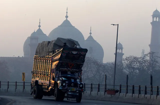 A truck turns on an overpass beside the Badshahi Mosque in Lahore, Pakistan March 11, 2018. (Photo by Caren Firouz/Reuters)