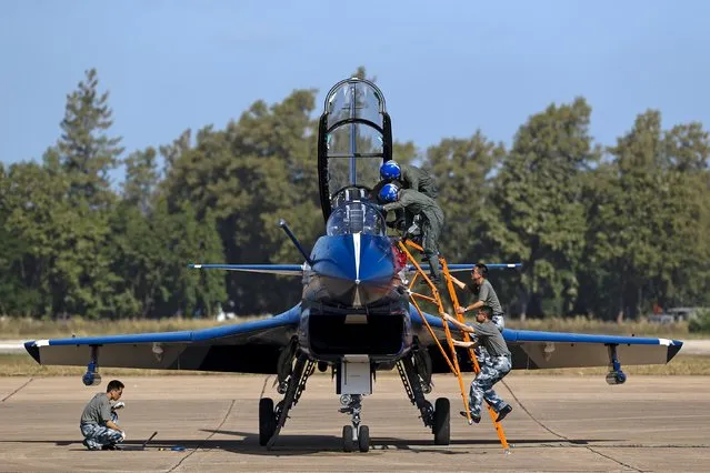 Pilots of China's J-10 fighter jet from the People's Liberation Army Air Force August 1st Aerobatics Team prepare before a media demonstration at the Korat Royal Thai Air Force Base, Nakhon Ratchasima province, Thailand, November 24, 2015. (Photo by Athit Perawongmetha/Reuters)