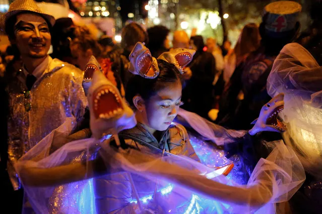 A girl dressed as a Sharknado waits in a staging area before participating in the Greenwich Village Halloween Parade in Manhattan, New York, U.S., October 31, 2016. (Photo by Andrew Kelly/Reuters)