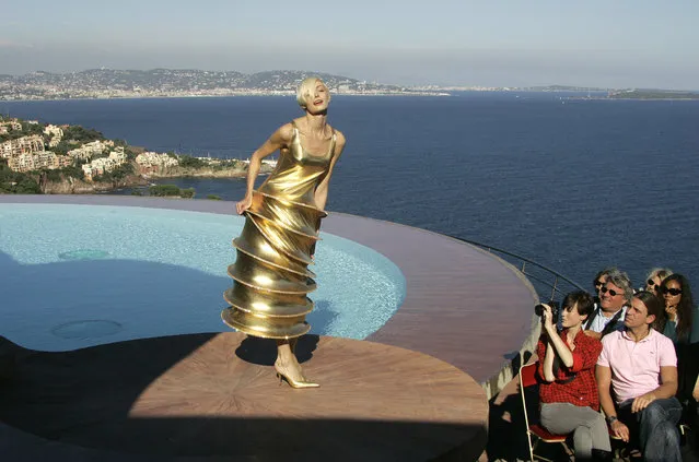 In this October 6, 2008 file photo, a model wears a creation by French fashion designer Pierre Cardin during the presentation of his entire Spring-Summer 2009 and Autumn-Winter 2009 collections at his villa in Theoule sur Mer, southern France.Pierre Cardin, the French designer whose famous name embossed myriad consumer products after his iconic Space Age styles shot him into the fashion stratosphere in the 1960s, has died, the French Academy of Fine Arts said Tuesday. He was 98. (Photo by Lionel Cironneau/AP Photo/File)