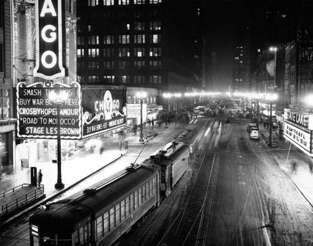 This nighttime view looking south from Lake Street shows an illuminated State Street in the downtown district of Chicago's Loop, which is not affected by the wartime dimout, on January 6, 1943. (Photo by AP Photo)