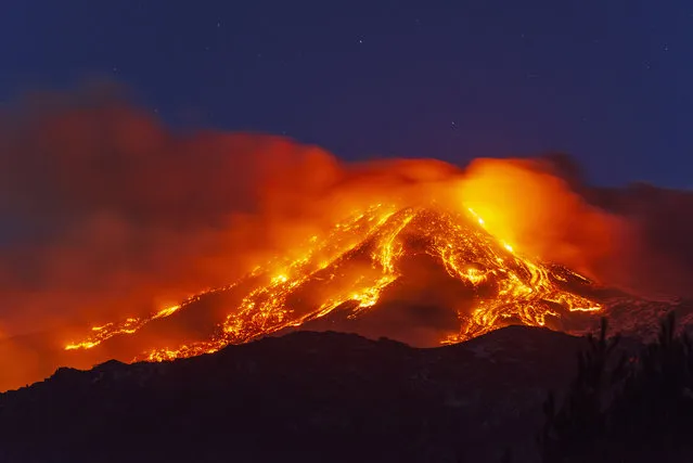 Lava gushes from the Mt Etna volcano near Catania, Sicily, Tuesday, February 16, 2021. Europe's most active volcano came alive around 4 pm local time on Tuesday, according to the Italian Institute of Geophysics and Volcanology. (Photo by Salvatore Allegra/AP Photo)