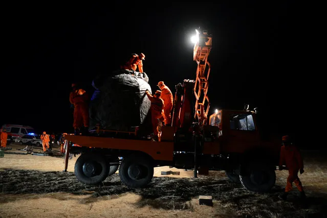 The re-entry capsule of China's Shenzhou-11 spacecraft is loaded on a truck, north of Inner Mongolia Autonomous Region, China, November 18, 2016. (Photo by Reuters/China Daily)