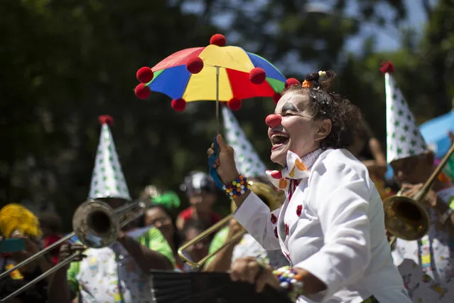 A reveler dances during the “Gigantes da Lira” carnival parade in Rio de Janeiro, Brazil, Sunday, February 8, 2015. (Photo by Felipe Dana/AP Photo)