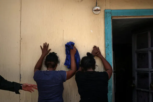 Women from the Dominican Republic are apprehended by the border patrol for illegally crossing into the U.S. border from Mexico in Los Ebanos, Texas, U.S., August 15, 2018. (Photo by Adrees Latif/Reuters)
