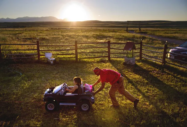 Randy Ortiz, right, pushes Ronnie Loring, 3, the cousin of Ashley HeavyRunner Loring, as they take a break from searching for her on the Blackfeet Indian Reservation in Browning, Mont., Thursday July 12, 2018. The family has logged about 40 searches but there's no way to cover a 1.5 million acre reservation, an expanse larger than Delaware. (Photo by David Goldman/AP Photo)