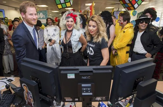 Britain's Prince Harry takes part in a charity trading day at ICAP with Kate Arnold and Samantha Bennett on the EBS Direct Desk in support of his charity Sentebale, in London, December 7, 2016. (Photo by Geoff Pugh/Reuters)