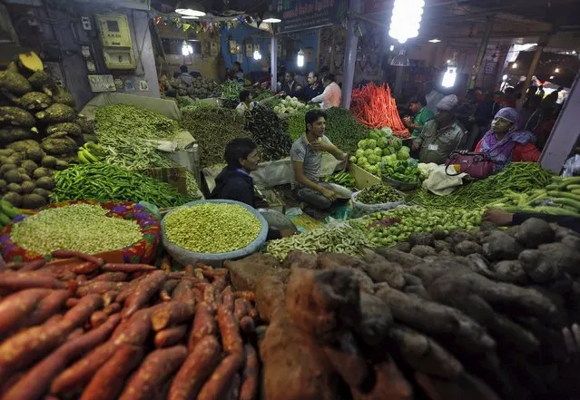 Customers buy vegetables from a stall at a market in Ahmedabad, India, January 12, 2016. (Photo by Amit Dave/Reuters)
