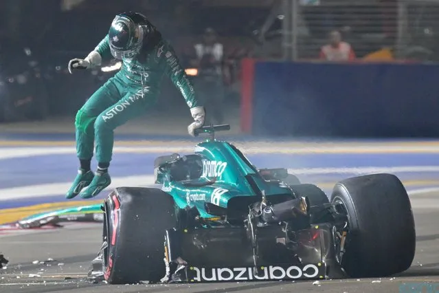 Aston Martin driver Lance Stroll of Canada jumps out from his car after a crash during the qualifying session of the Singapore Formula One Grand Prix at the Marina Bay circuit, Singapore, Saturday, September 16, 2023. (Photo by Caroline Chia/Pool Photo via AP Photo)