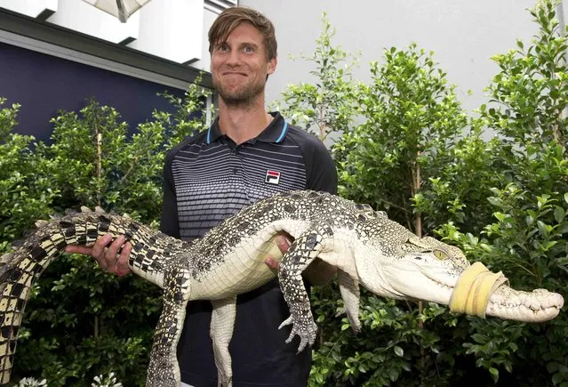 Italy's Andreas Seppi poses with a baby crocodile during a promotional event at the Australian Open tennis tournament at Melbourne Park, Australia, in this January 21, 2016 handout photo. (Photo by Fiona Hamilton/Reuters)
