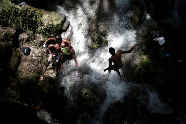 Pilgrims take a bath during the celebration of the annual pilgrimage to the waterfall in Saut D'Eau, Haiti on July 16, 2018. (Photo by Andres Martinez Casares/Reuters)