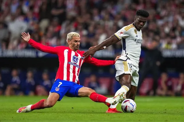 Atletico Madrid's Antoine Griezmann, left, vies for the ball with Real Madrid's Aurelien Tchouameni during the Spanish La Liga soccer match between Atletico Madrid and Real Madrid at Metropolitan stadium in Madrid, Sunday, September 24, 2023. Atletico Madrid won 3-1. (Photo by Manu Fernandez/AP Photo)